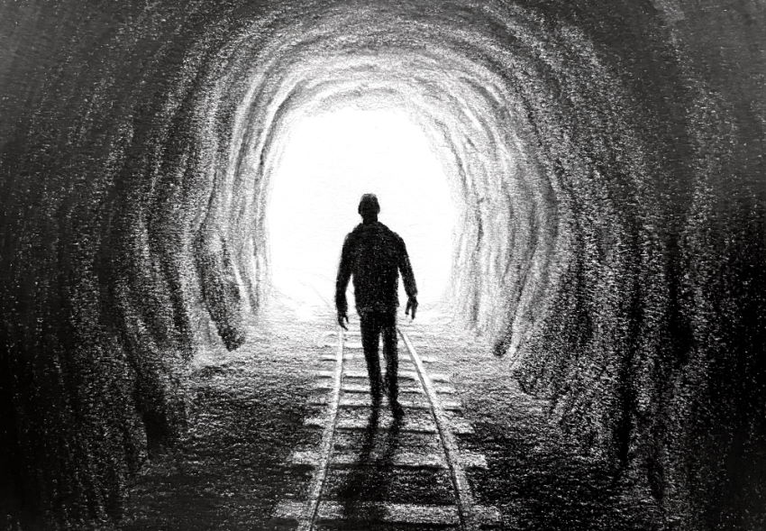 Pencil drawing of a man walking in a cave