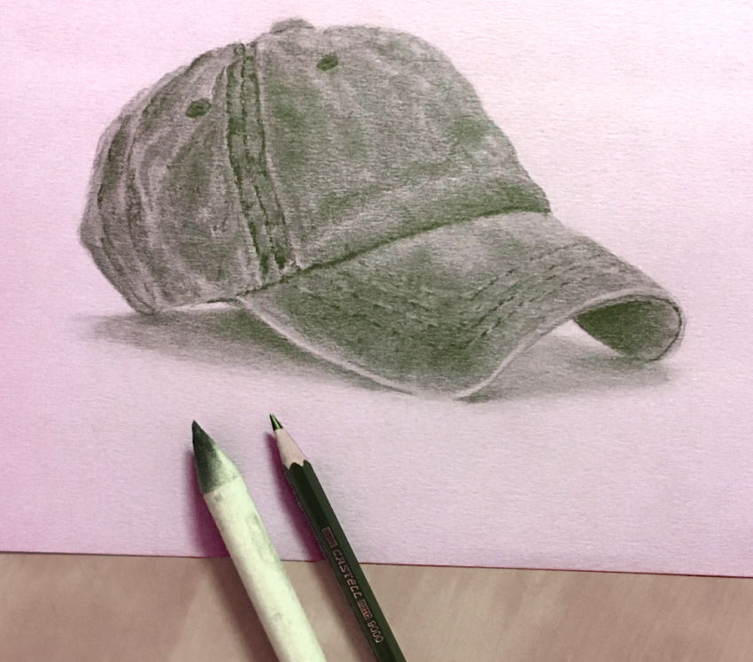 Pencil drawing of a hat on pink paper